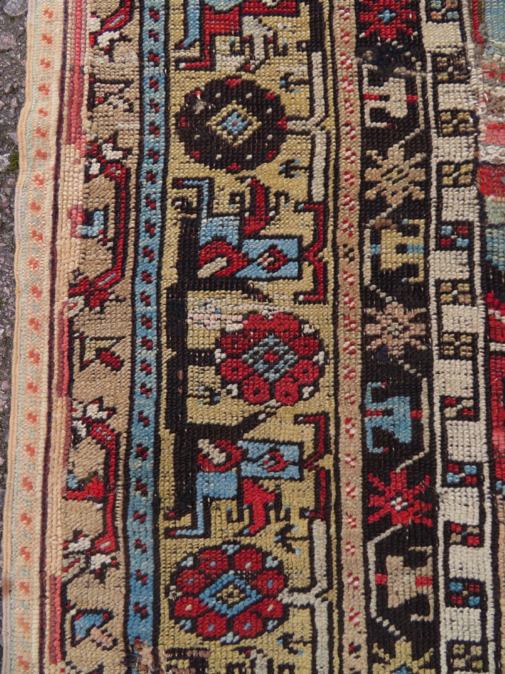 An antique hand-knotted Turkish Ladik wool prayer rug featuring a central pale blue mihrab niche, inverted tulip motifs, and multi-coloured geometric borders. View XV