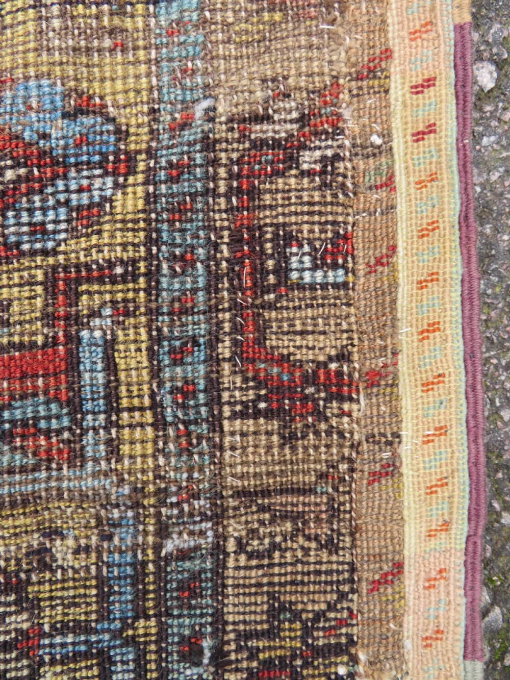 An antique hand-knotted Turkish Ladik wool prayer rug featuring a central pale blue mihrab niche, inverted tulip motifs, and multi-coloured geometric borders. View XXII
