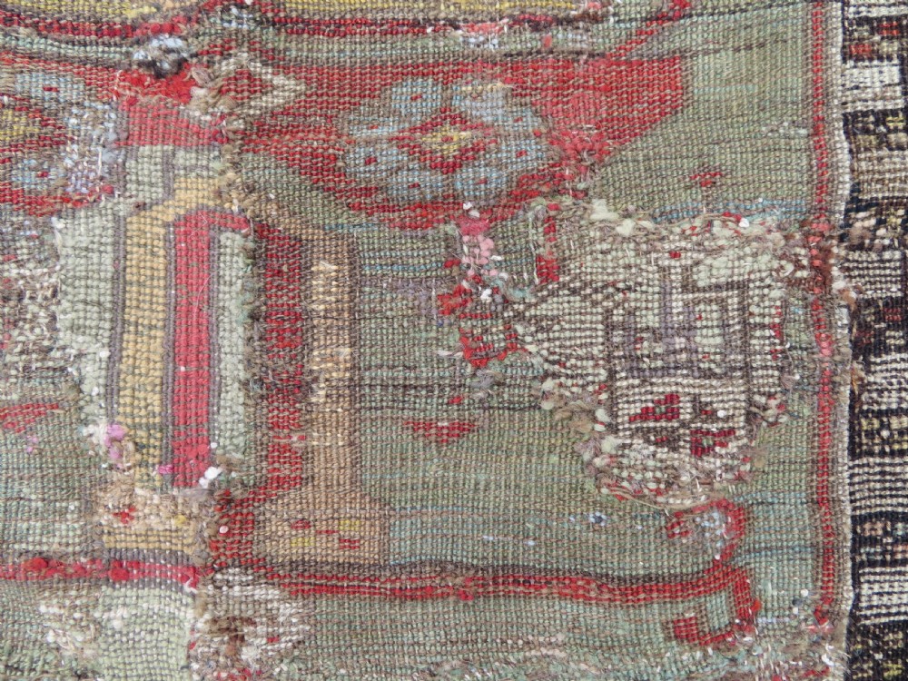 An antique hand-knotted Turkish Ladik wool prayer rug featuring a central pale blue mihrab niche, inverted tulip motifs, and multi-coloured geometric borders. View XXIII
