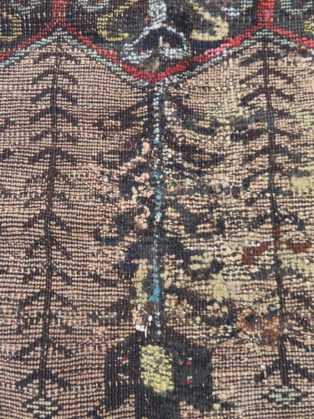 An antique hand-knotted Turkish Ladik wool prayer rug featuring a central pale blue mihrab niche, inverted tulip motifs, and multi-coloured geometric borders. View XXVI