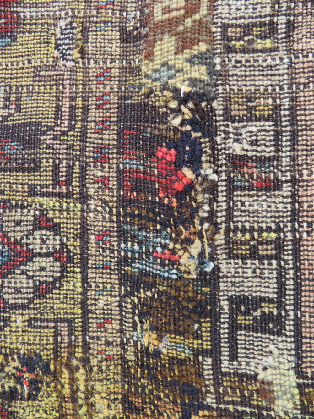 An antique hand-knotted Turkish Ladik wool prayer rug featuring a central pale blue mihrab niche, inverted tulip motifs, and multi-coloured geometric borders. View XXVII