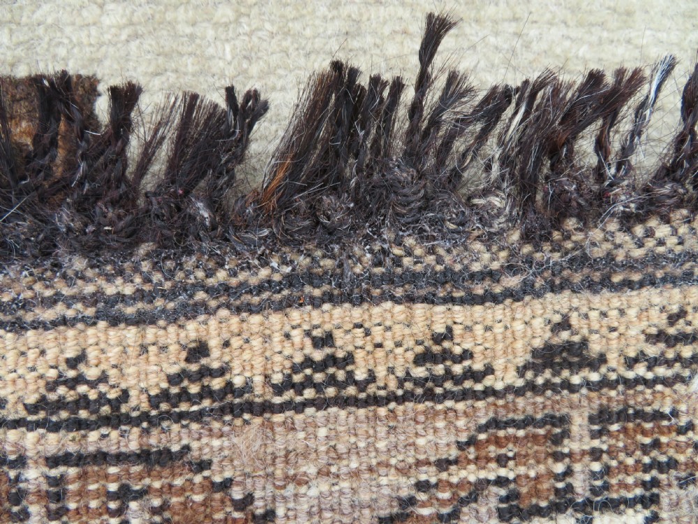An antique hand-knotted wool Gabbeh rug with five central geometric diamond medallions in brown set against a cream field with a detailed geometric border. View XIII