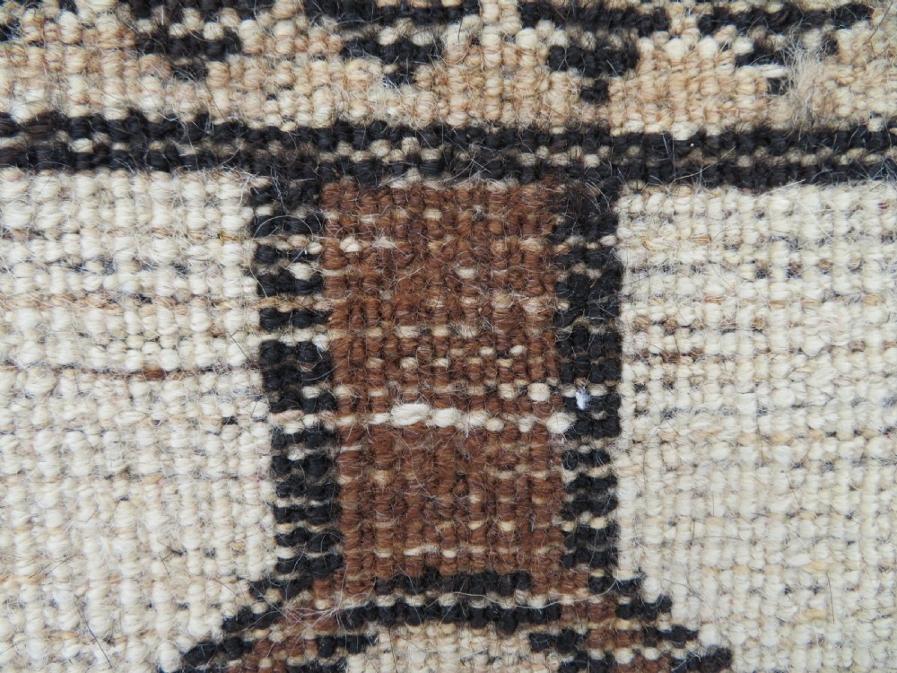 An antique hand-knotted wool Gabbeh rug with five central geometric diamond medallions in brown set against a cream field with a detailed geometric border. View XIV