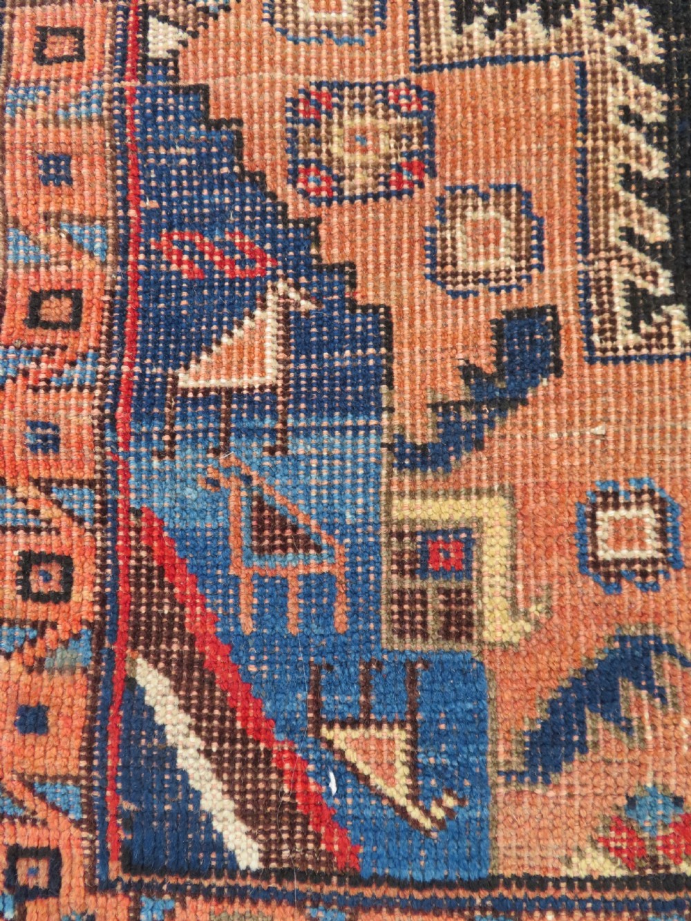 An antique hand-knotted Afshar wool rug featuring a central stepped geometric medallion in rust red and blue framed by intricate tribal borders. View IV