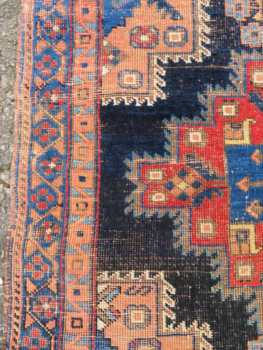 An antique hand-knotted Afshar wool rug featuring a central stepped geometric medallion in rust red and blue framed by intricate tribal borders. View VII