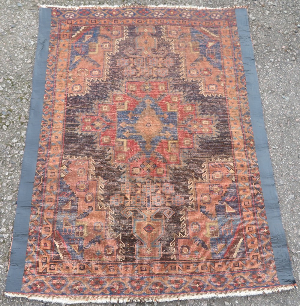 An antique hand-knotted Afshar wool rug featuring a central stepped geometric medallion in rust red and blue framed by intricate tribal borders. View VIII