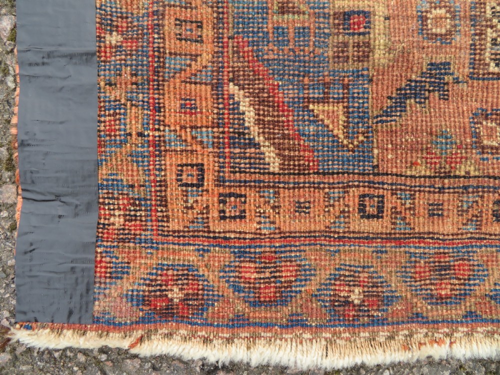 An antique hand-knotted Afshar wool rug featuring a central stepped geometric medallion in rust red and blue framed by intricate tribal borders. View IX