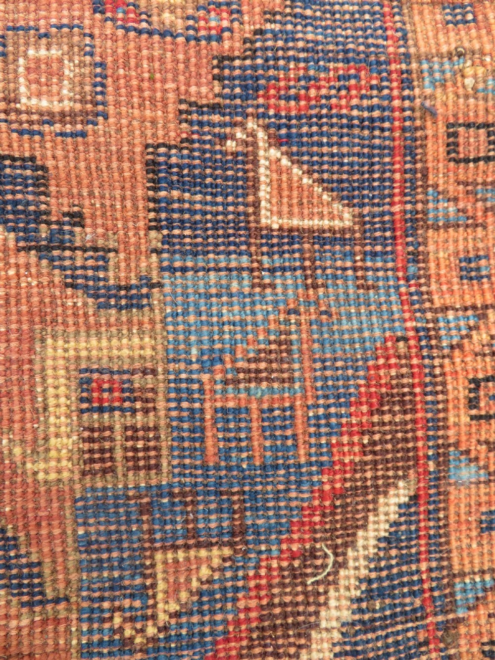 An antique hand-knotted Afshar wool rug featuring a central stepped geometric medallion in rust red and blue framed by intricate tribal borders. View X