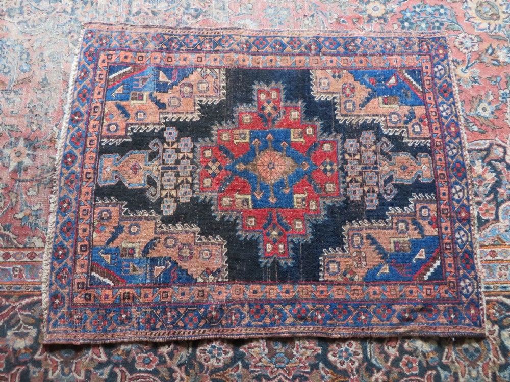 An antique hand-knotted Afshar wool rug featuring a central stepped geometric medallion in rust red and blue framed by intricate tribal borders. View XII