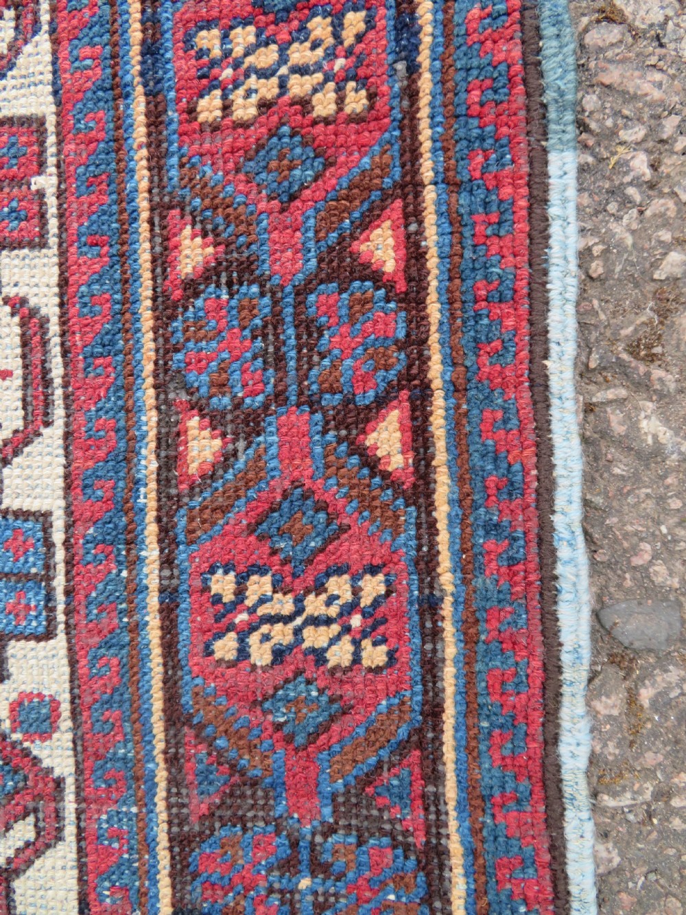 A hand-knotted antique Afshar tribal wool rug featuring a red stepped medallion on an indigo blue field surrounded by geometric borders. View VII