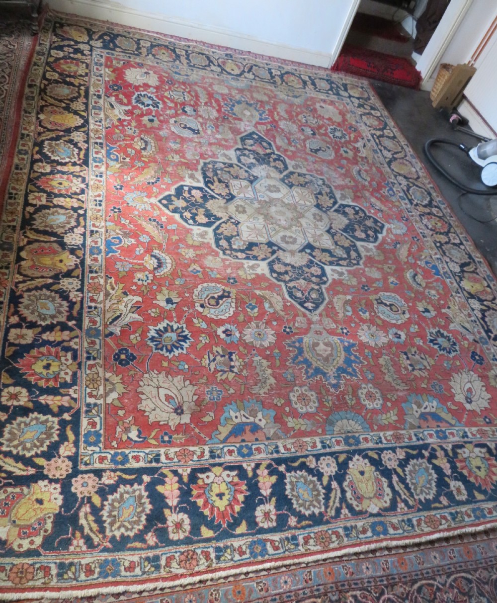 An antique hand-knotted Tabriz wool carpet featuring a central navy and cream medallion on a terracotta field with intricate floral borders. View II