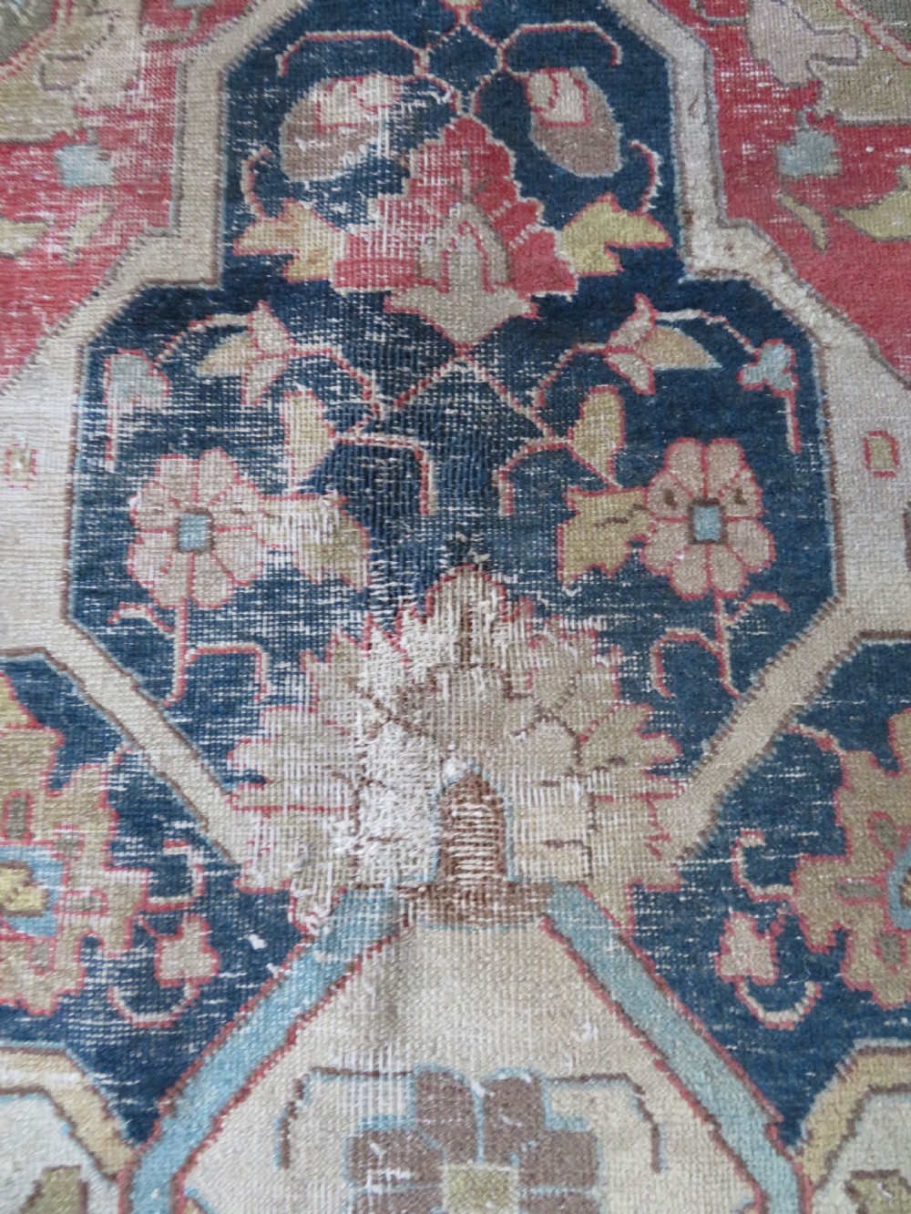 An antique hand-knotted Tabriz wool carpet featuring a central navy and cream medallion on a terracotta field with intricate floral borders. View VII