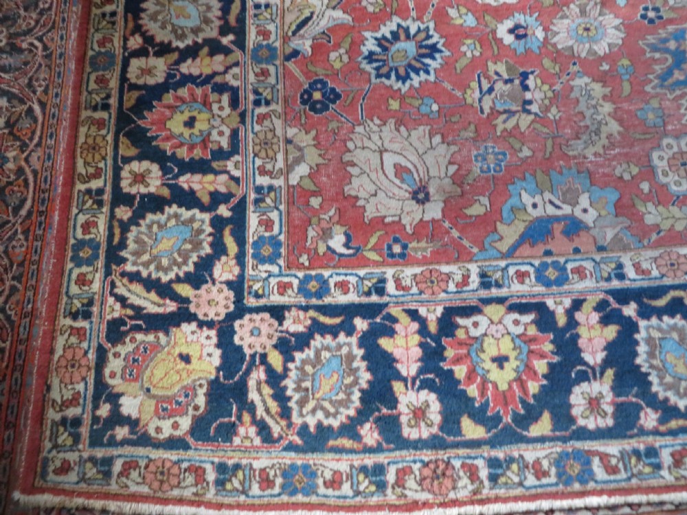 An antique hand-knotted Tabriz wool carpet featuring a central navy and cream medallion on a terracotta field with intricate floral borders. View IX