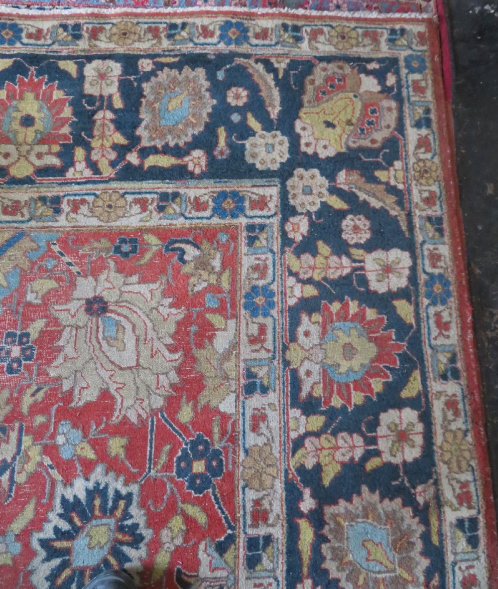 An antique hand-knotted Tabriz wool carpet featuring a central navy and cream medallion on a terracotta field with intricate floral borders. View XI