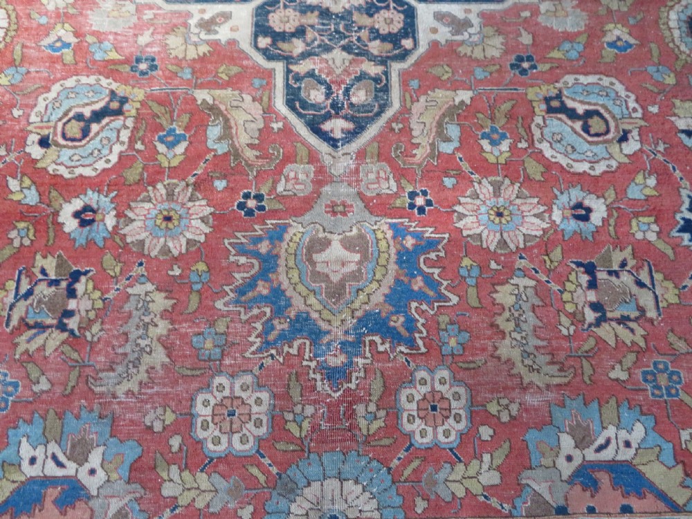 An antique hand-knotted Tabriz wool carpet featuring a central navy and cream medallion on a terracotta field with intricate floral borders. View XIII