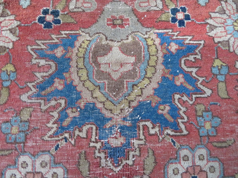 An antique hand-knotted Tabriz wool carpet featuring a central navy and cream medallion on a terracotta field with intricate floral borders. View XIV