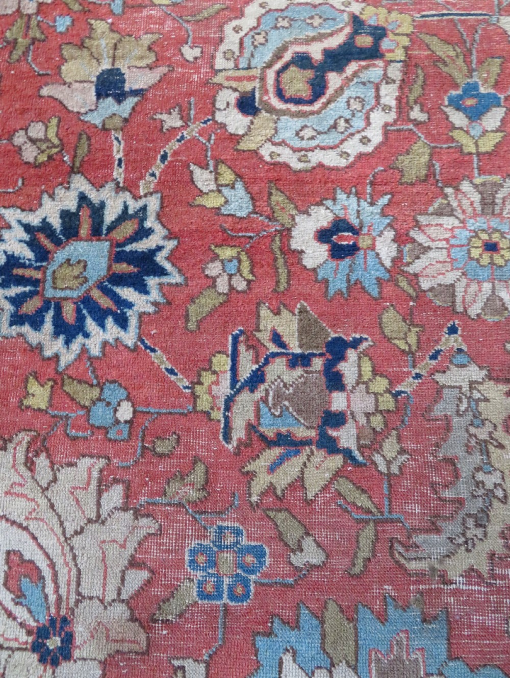 An antique hand-knotted Tabriz wool carpet featuring a central navy and cream medallion on a terracotta field with intricate floral borders. View XV