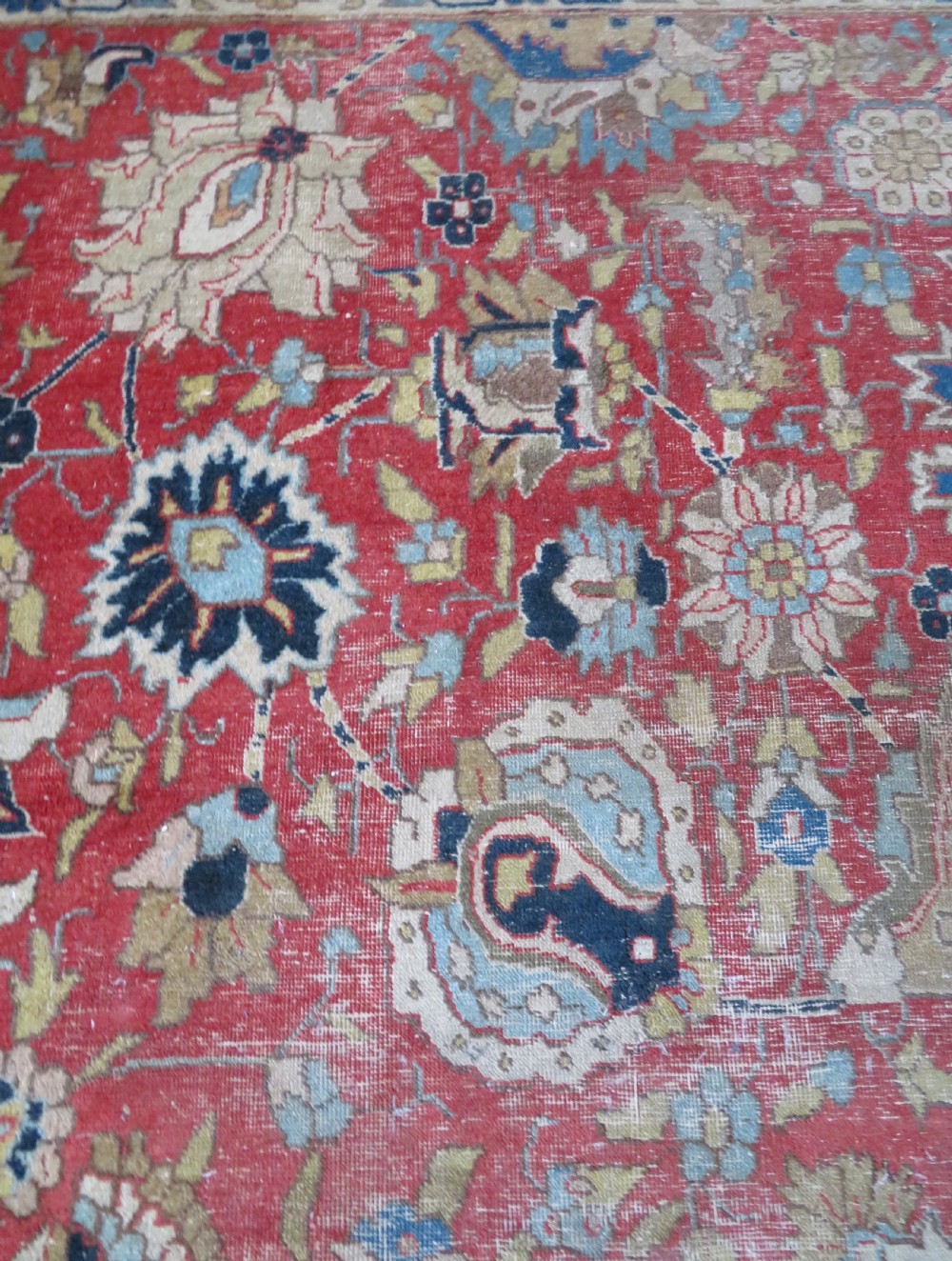 An antique hand-knotted Tabriz wool carpet featuring a central navy and cream medallion on a terracotta field with intricate floral borders. View XVI