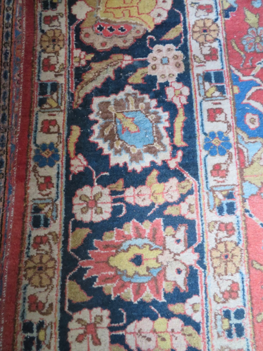 An antique hand-knotted Tabriz wool carpet featuring a central navy and cream medallion on a terracotta field with intricate floral borders. View XVII