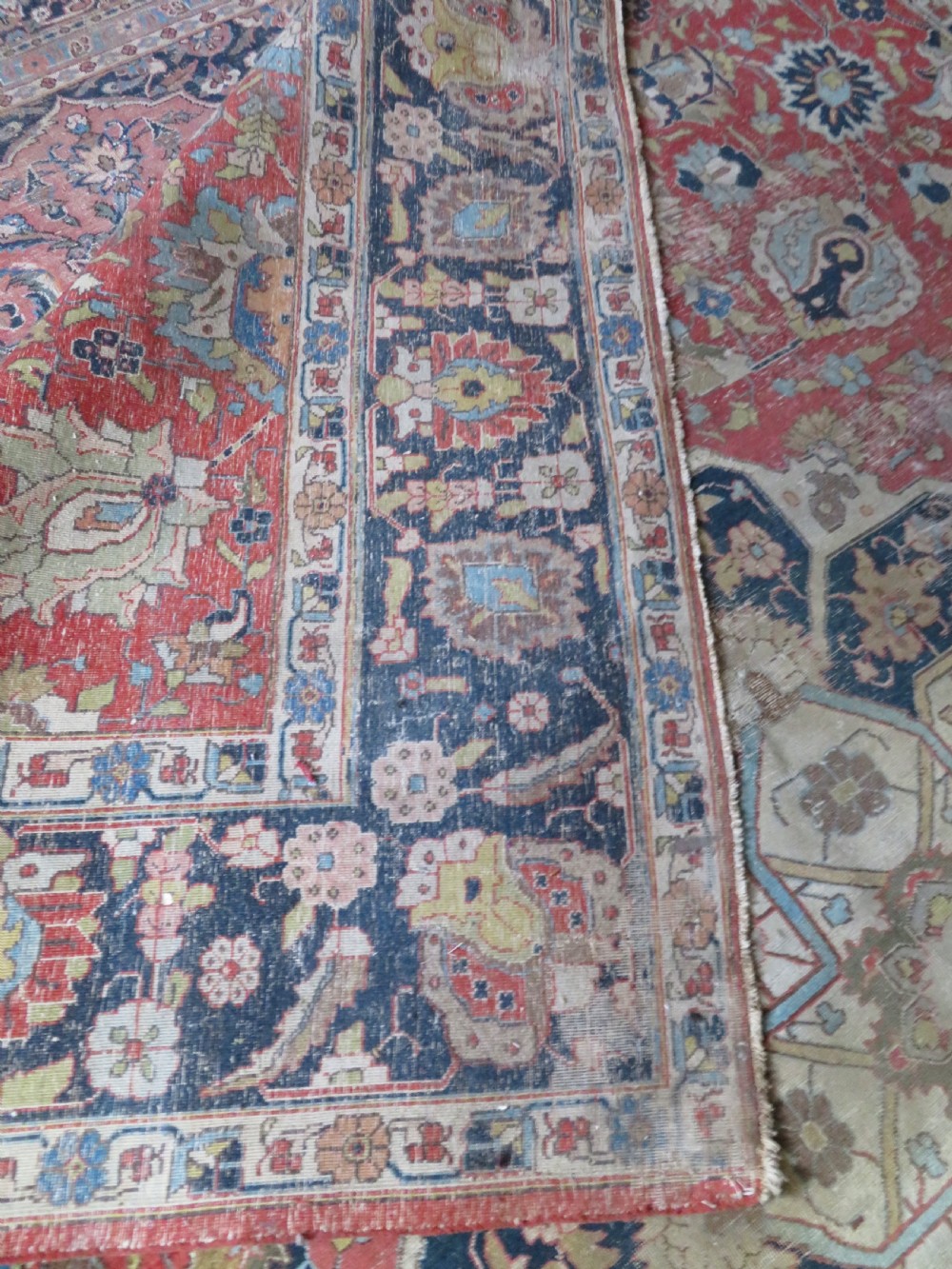 An antique hand-knotted Tabriz wool carpet featuring a central navy and cream medallion on a terracotta field with intricate floral borders. View XVIII