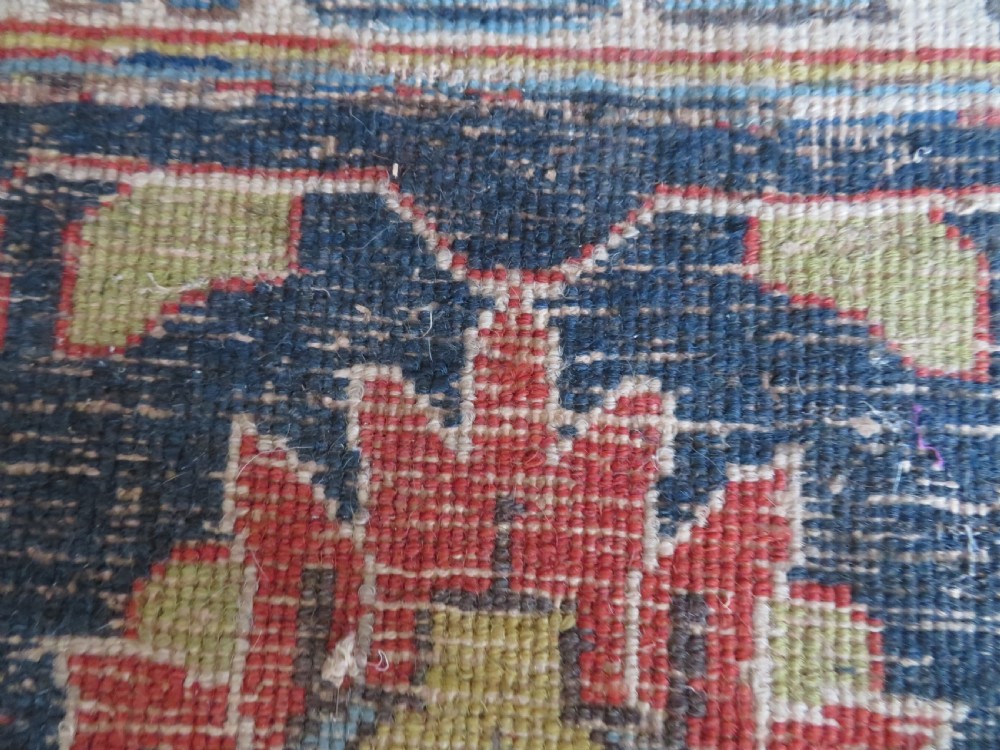 An antique hand-knotted Tabriz wool carpet featuring a central navy and cream medallion on a terracotta field with intricate floral borders. View XX