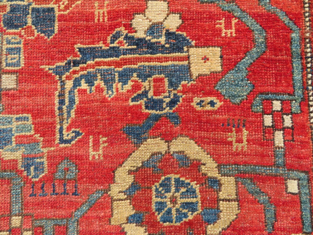 An antique Kurdish Bidjar Kelleh hand-knotted carpet featuring geometric diamond medallions on a terracotta red field with dark navy blue borders. View XIV