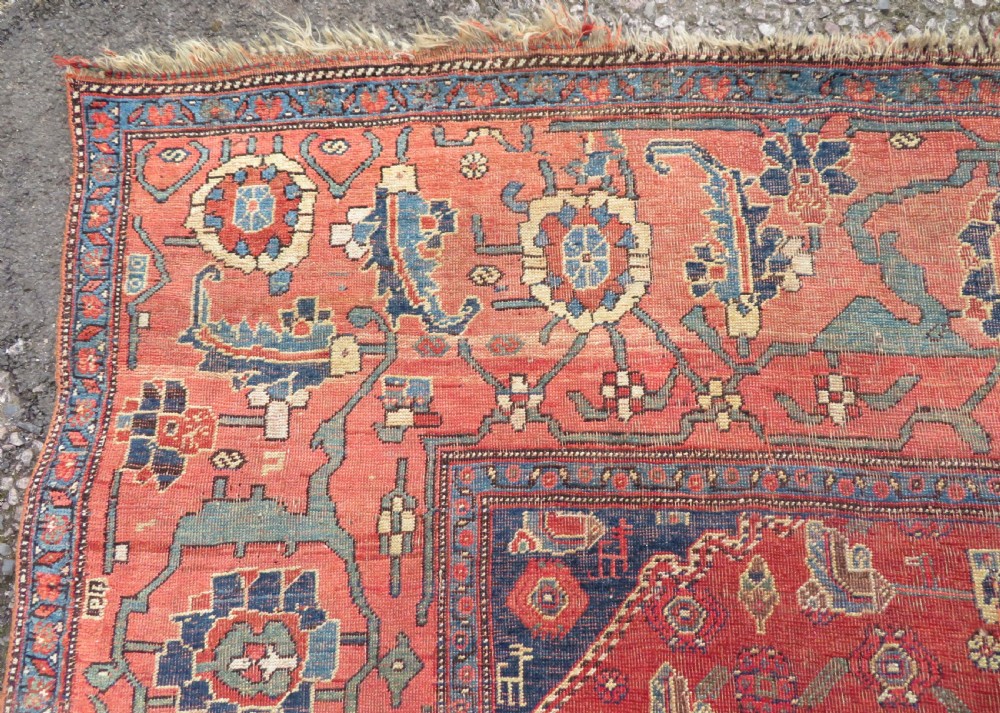 An antique Kurdish Bidjar Kelleh hand-knotted carpet featuring geometric diamond medallions on a terracotta red field with dark navy blue borders. View XVI