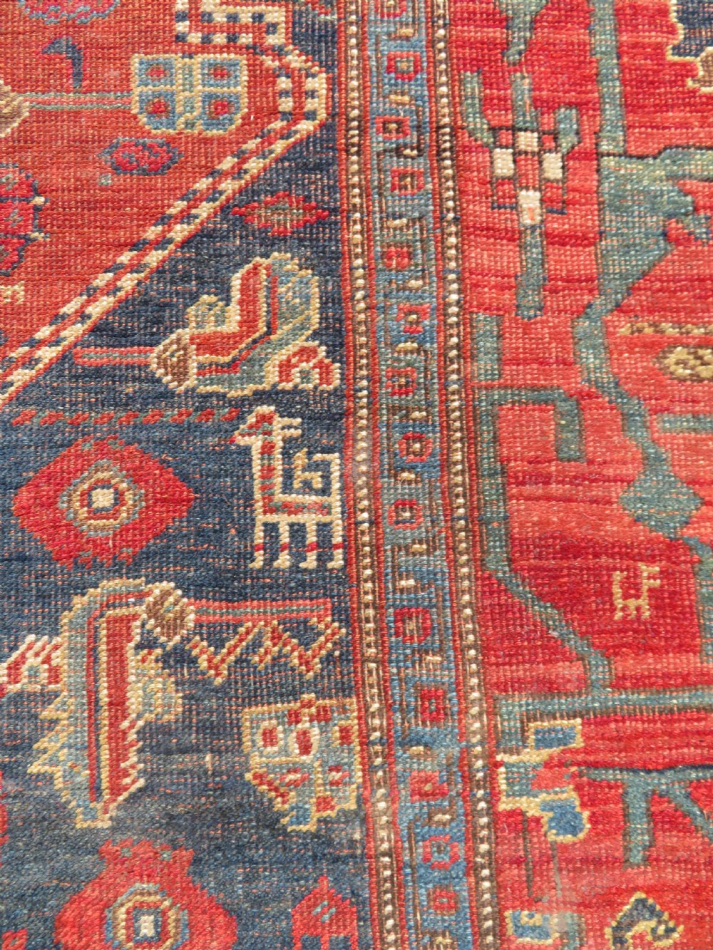 An antique Kurdish Bidjar Kelleh hand-knotted carpet featuring geometric diamond medallions on a terracotta red field with dark navy blue borders. View XIX