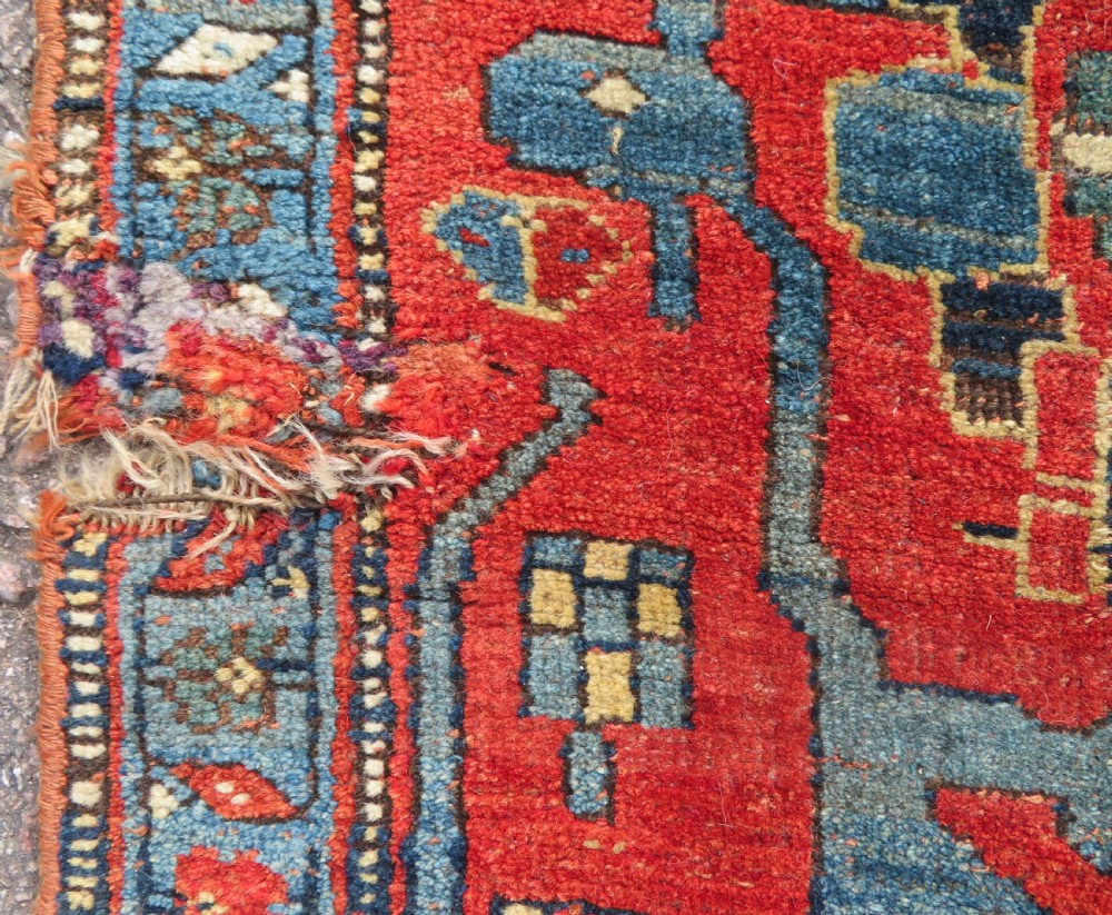 An antique Kurdish Bidjar Kelleh hand-knotted carpet featuring geometric diamond medallions on a terracotta red field with dark navy blue borders. View XXI