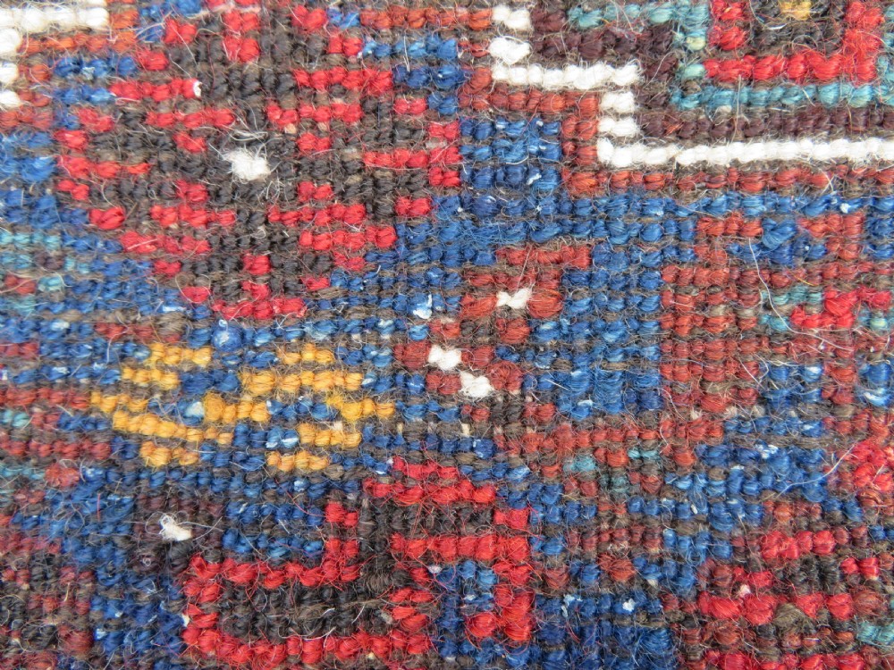 An antique Khamseh hand-knotted wool tribal rug featuring three central diamond medallions surrounded by small bird and geometric motifs in deep blue, terracotta red, and cream. View XX