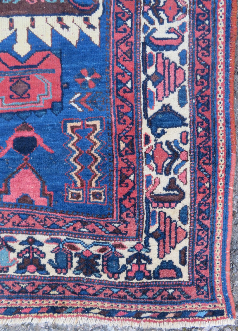 An antique hand-knotted Afshar wool rug featuring a vibrant indigo blue central field with stylized geometric medallions surrounded by detailed terracotta red and ivory borders. View VIII