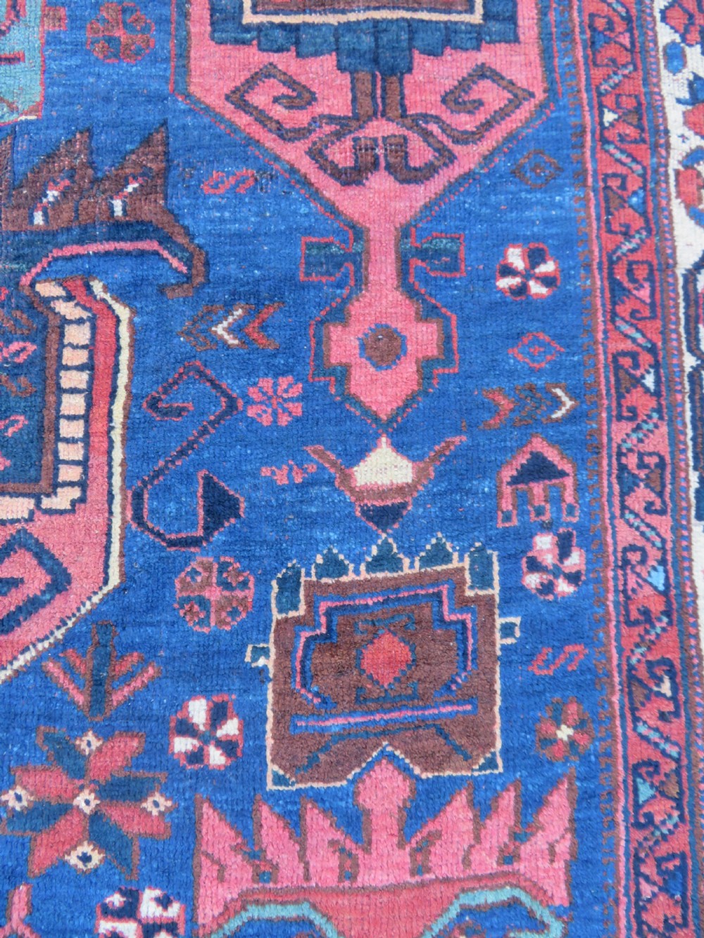 An antique hand-knotted Afshar wool rug featuring a vibrant indigo blue central field with stylized geometric medallions surrounded by detailed terracotta red and ivory borders. View XI