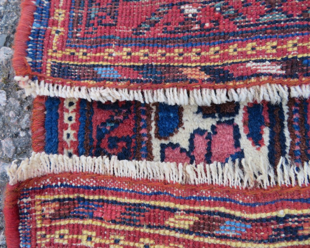 An antique hand-knotted Afshar wool rug featuring a vibrant indigo blue central field with stylized geometric medallions surrounded by detailed terracotta red and ivory borders. View XIII
