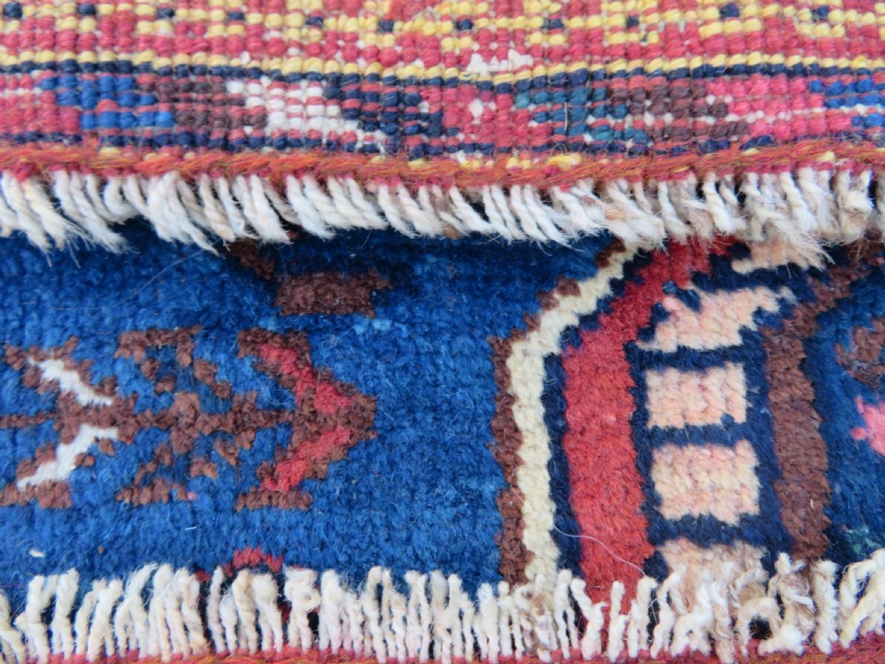 An antique hand-knotted Afshar wool rug featuring a vibrant indigo blue central field with stylized geometric medallions surrounded by detailed terracotta red and ivory borders. View XV