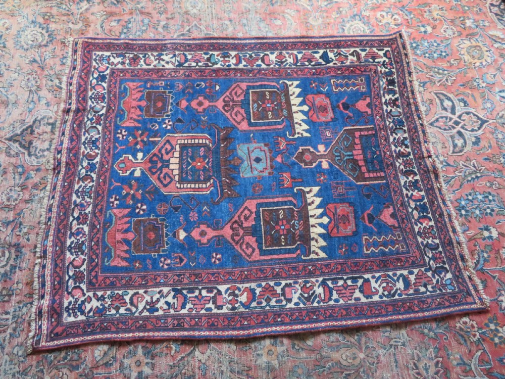 An antique hand-knotted Afshar wool rug featuring a vibrant indigo blue central field with stylized geometric medallions surrounded by detailed terracotta red and ivory borders. View XXIII