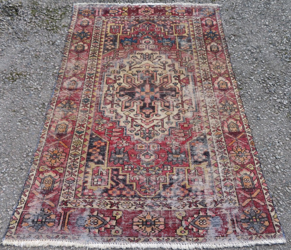 An antique hand-knotted wool Persian Malayer rug featuring a central geometric medallion on a cream and terracotta red field with multi-tiered borders.