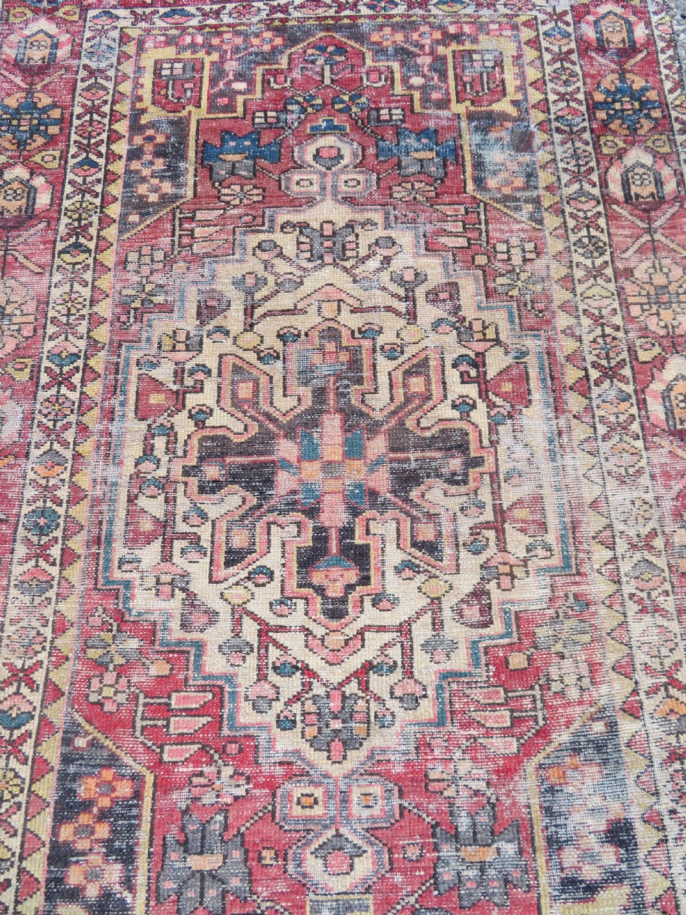 An antique hand-knotted wool Persian Malayer rug featuring a central geometric medallion on a cream and terracotta red field with multi-tiered borders. View III