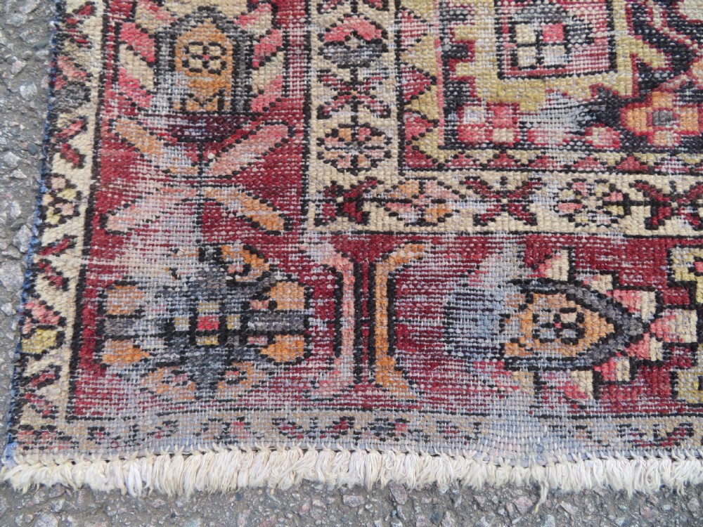 An antique hand-knotted wool Persian Malayer rug featuring a central geometric medallion on a cream and terracotta red field with multi-tiered borders. View V