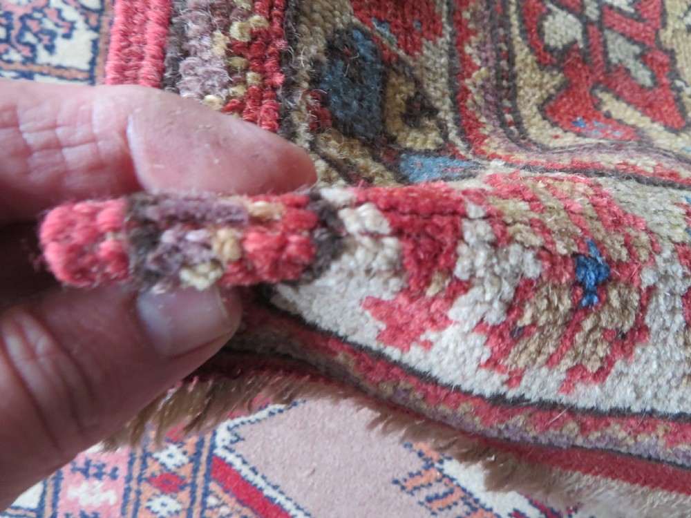 An antique hand-knotted Turkish Milas wool prayer rug featuring a central pointed arch motif in terracotta surrounded by broad geometric floral borders in cream, red, and blue shades. View XII