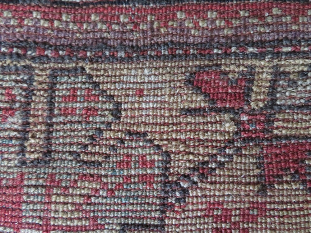 An antique hand-knotted Turkish Milas wool prayer rug featuring a central pointed arch motif in terracotta surrounded by broad geometric floral borders in cream, red, and blue shades. View XVIII