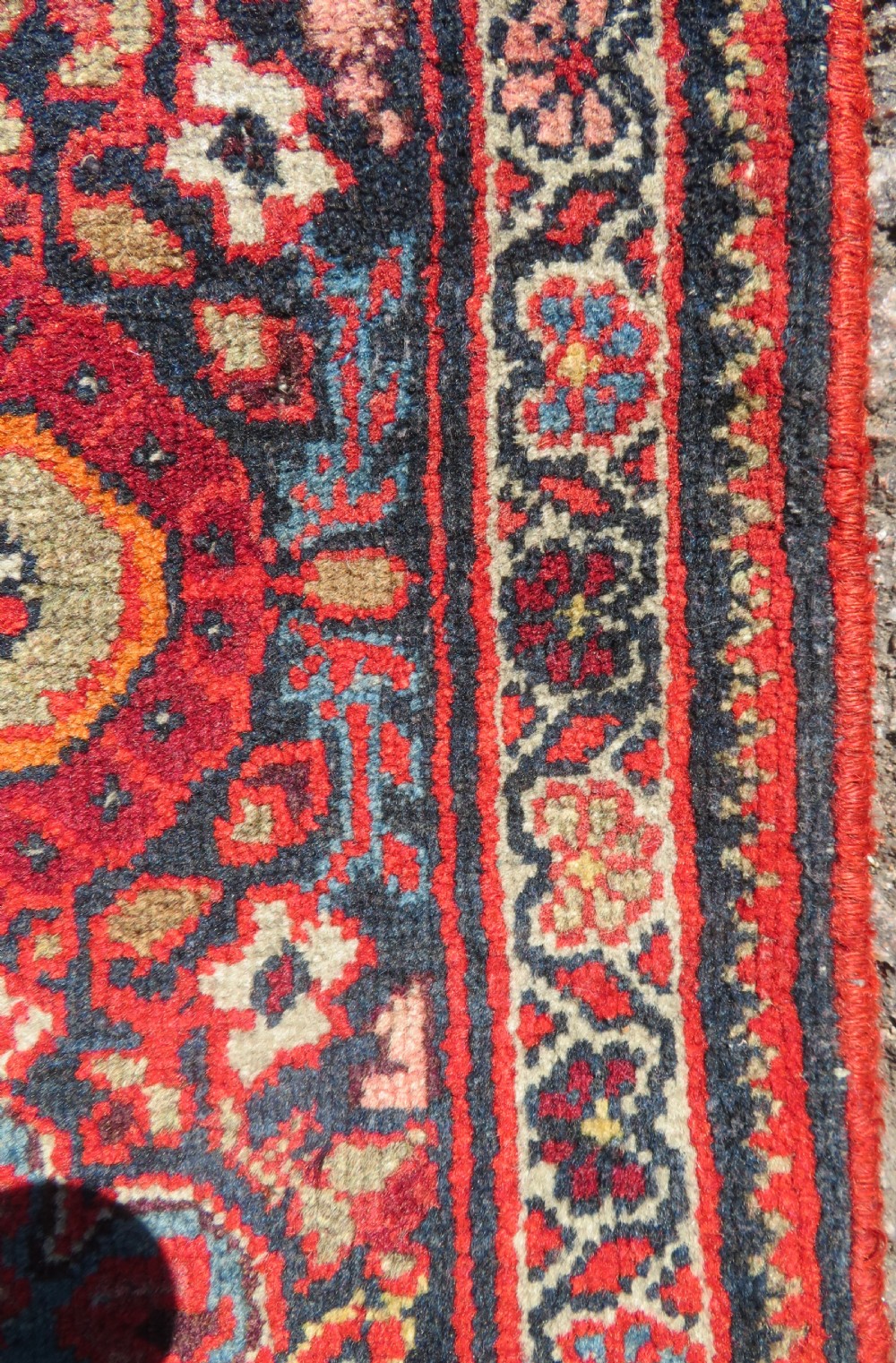 A hand-knotted antique Malayer rug featuring a central navy diamond medallion surrounded by elaborate geometric red and floral pattern borders. View VIII