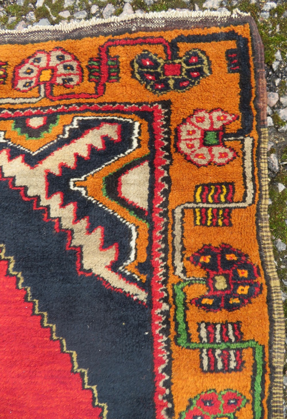 A hand-knotted Turkish Yahyali rug featuring a stepped central medallion in red, navy blue, and beige, framed by a broad ochre geometric border. View IV