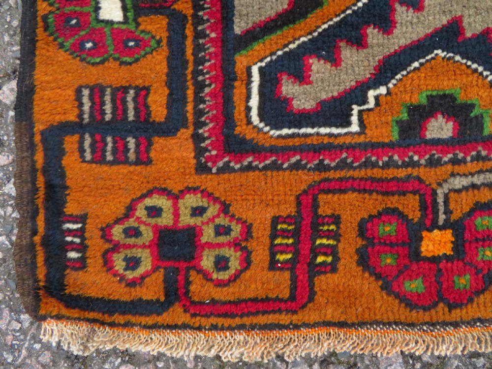 A hand-knotted Turkish Yahyali rug featuring a stepped central medallion in red, navy blue, and beige, framed by a broad ochre geometric border. View V