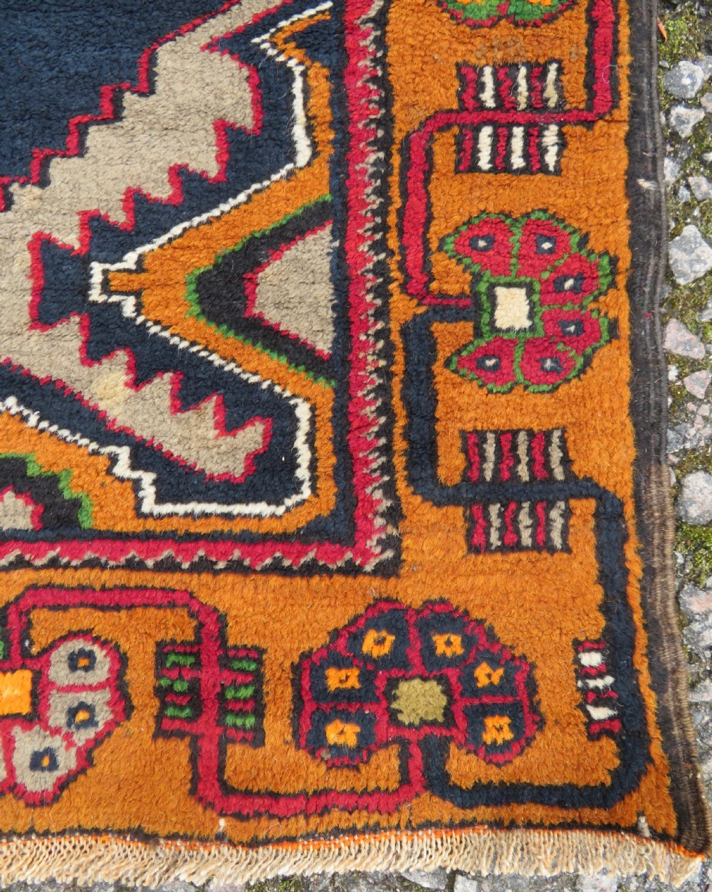 A hand-knotted Turkish Yahyali rug featuring a stepped central medallion in red, navy blue, and beige, framed by a broad ochre geometric border. View VII