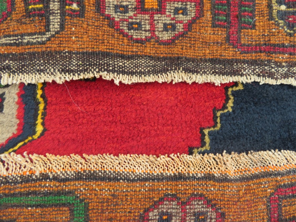 A hand-knotted Turkish Yahyali rug featuring a stepped central medallion in red, navy blue, and beige, framed by a broad ochre geometric border. View XI