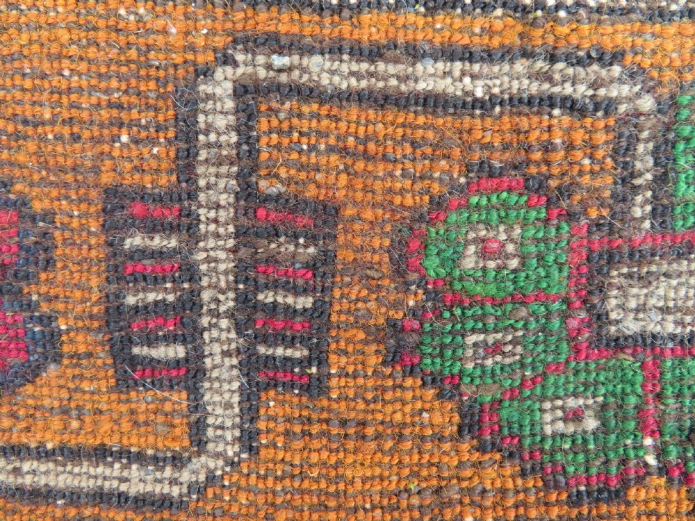 A hand-knotted Turkish Yahyali rug featuring a stepped central medallion in red, navy blue, and beige, framed by a broad ochre geometric border. View XII