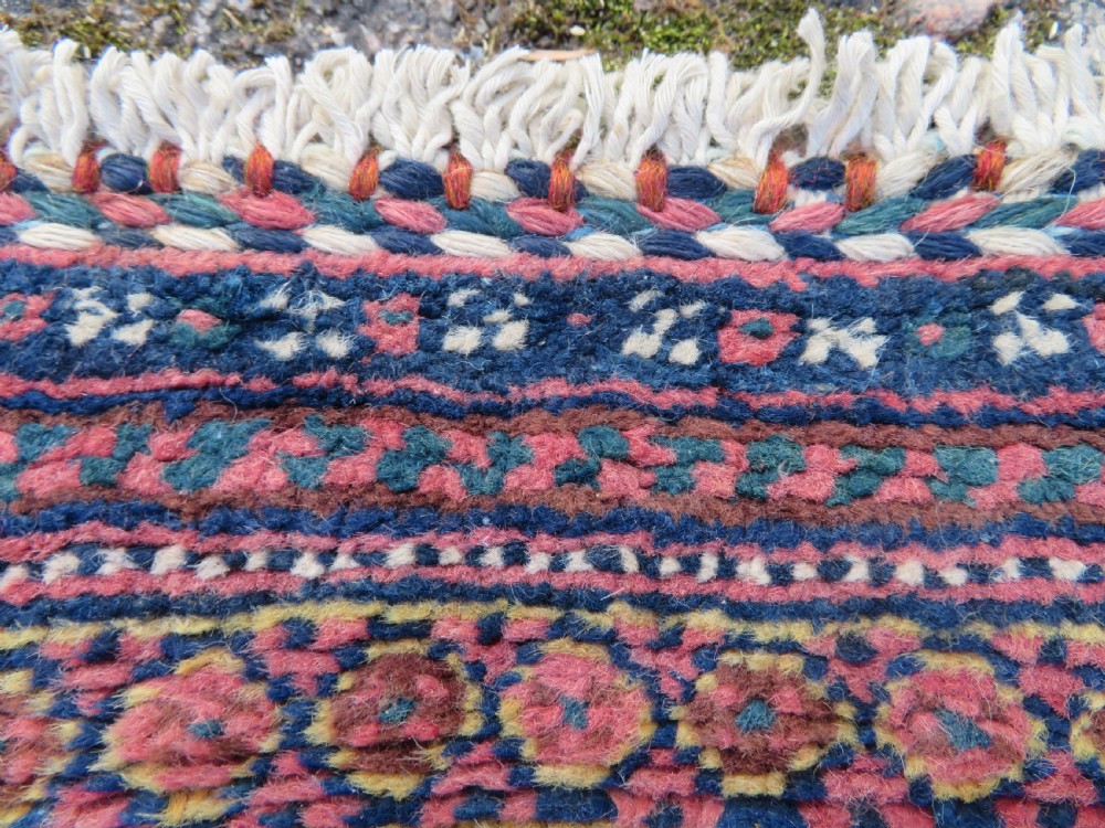 An antique hand-knotted Afshar wool rug featuring a repeating geometric motif on an ivory ground with dark blue and terracotta decorative borders. View X