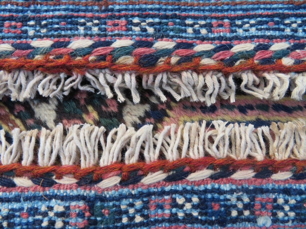 An antique hand-knotted Afshar wool rug featuring a repeating geometric motif on an ivory ground with dark blue and terracotta decorative borders. View XVI