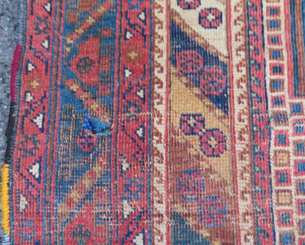 An antique Khamseh hand-knotted wool rug featuring five central diamond medallions on a dark navy and red field decorated with tribal bird motifs. View XV