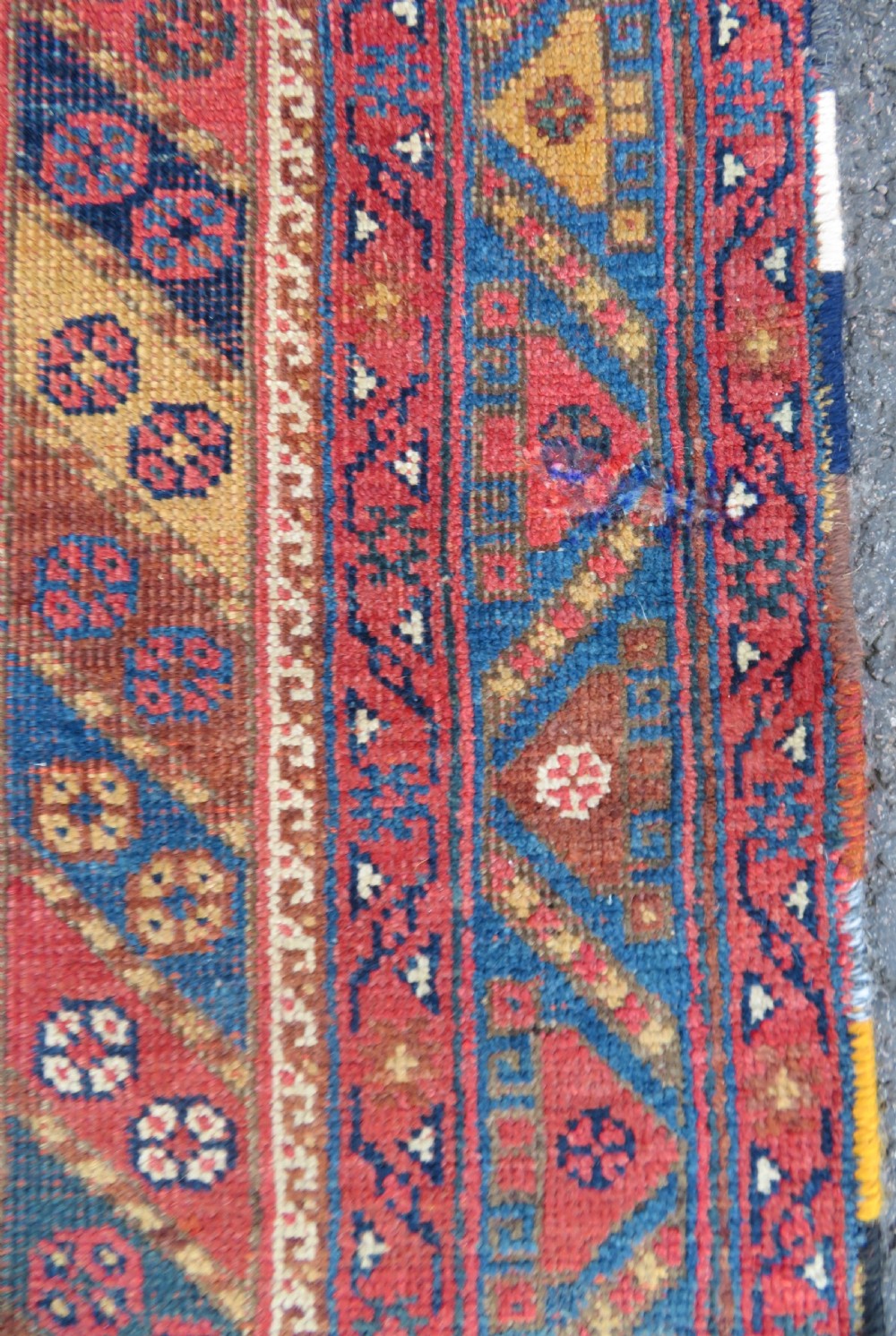 An antique Khamseh hand-knotted wool rug featuring five central diamond medallions on a dark navy and red field decorated with tribal bird motifs. View XVIII